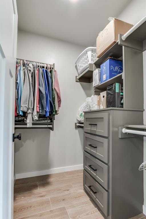 spacious closet featuring light wood-type flooring