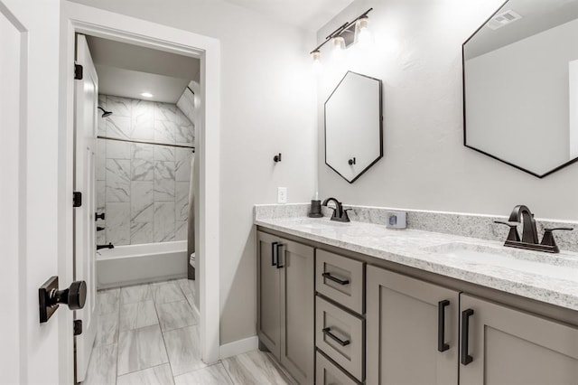 full bathroom with vanity, toilet, and tiled shower / bath