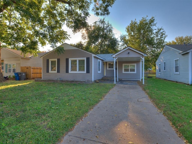 single story home featuring a front lawn and covered porch