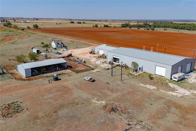 birds eye view of property with a rural view