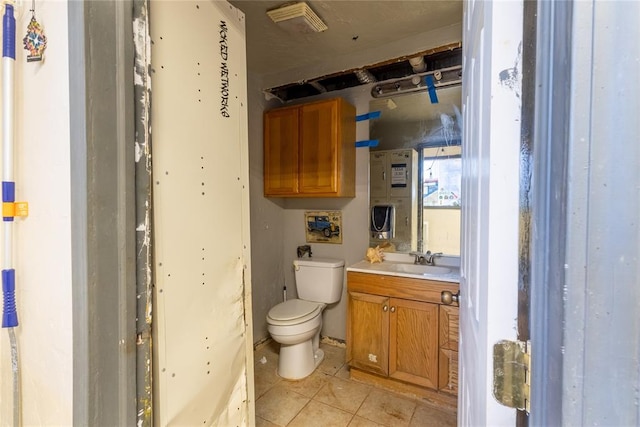 bathroom with tile patterned flooring, vanity, and toilet