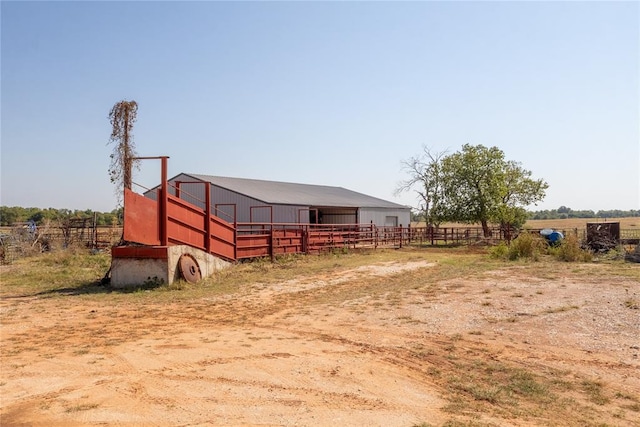 view of stable with a rural view