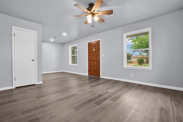 unfurnished room featuring ceiling fan and dark hardwood / wood-style flooring