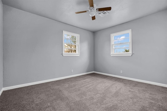 carpeted empty room featuring ceiling fan and a healthy amount of sunlight