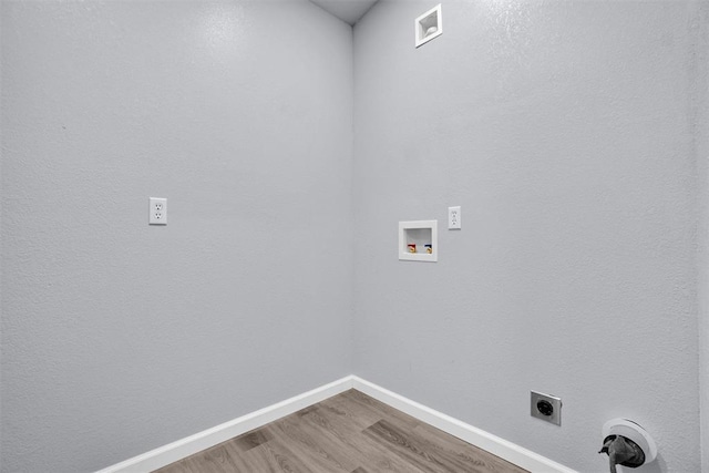 washroom with hookup for an electric dryer, wood-type flooring, and washer hookup