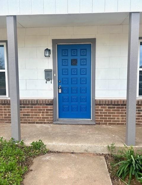 view of exterior entry with concrete block siding