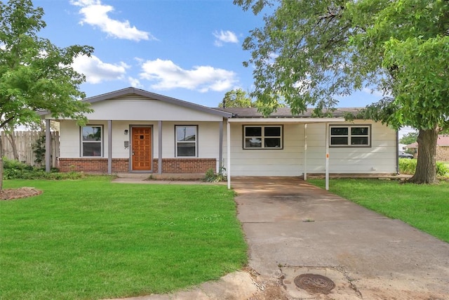 ranch-style house with a front lawn, driveway, fence, and brick siding