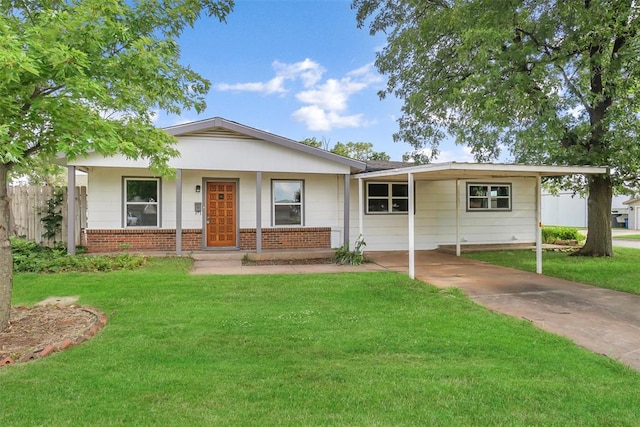 ranch-style house featuring fence, driveway, a front yard, brick siding, and a carport