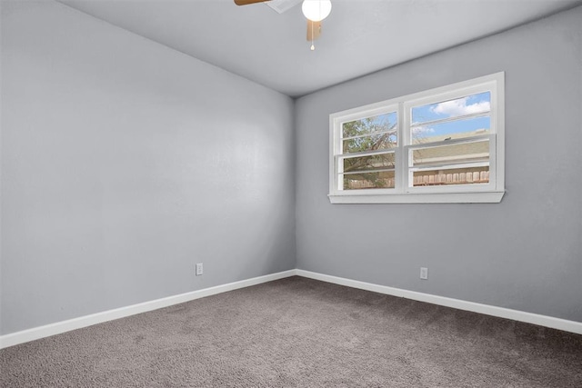 carpeted empty room featuring baseboards and ceiling fan
