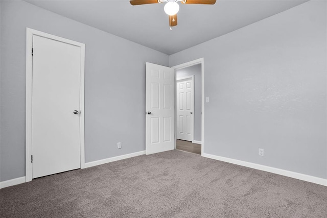 unfurnished bedroom with baseboards, ceiling fan, and carpet