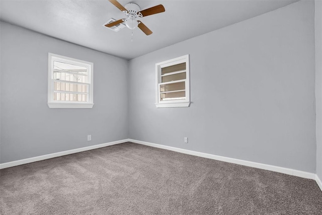 carpeted empty room featuring baseboards and ceiling fan