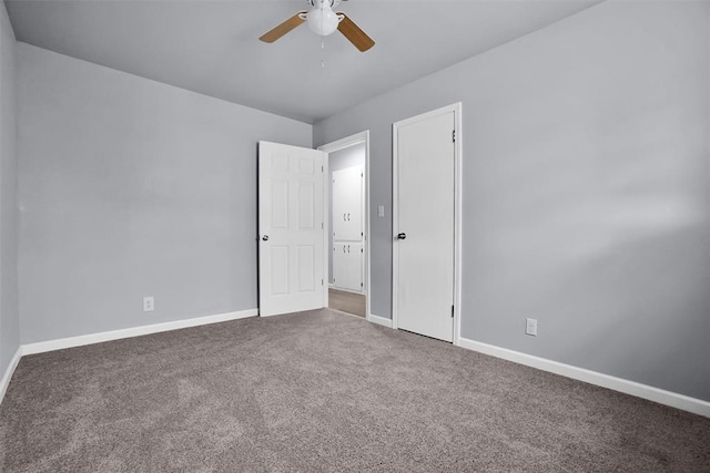 carpeted empty room with baseboards and ceiling fan