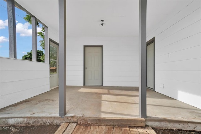 view of exterior entry featuring a patio