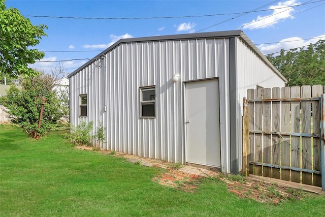 view of outbuilding featuring an outdoor structure and fence