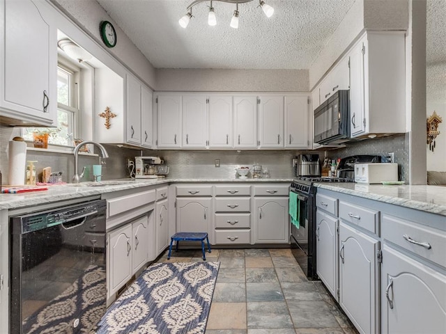 kitchen featuring a textured ceiling, white cabinetry, and black appliances