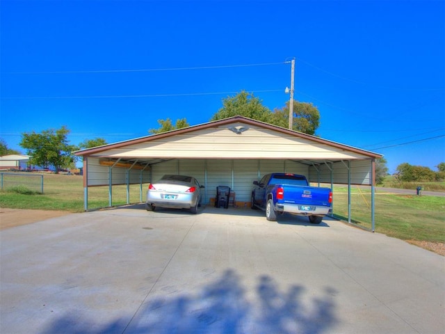 garage with a carport and a yard