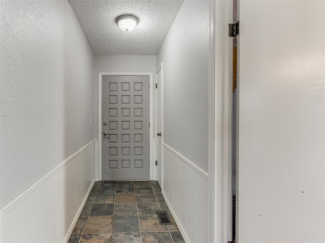 doorway featuring a textured ceiling