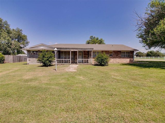 view of front of home featuring covered porch and a front yard