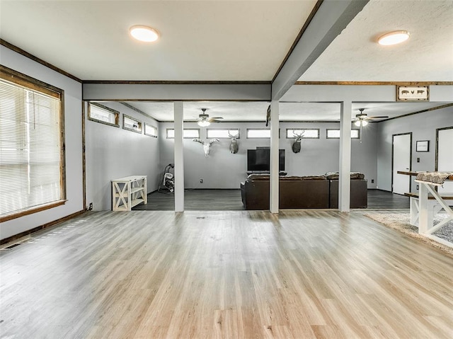 interior space with light hardwood / wood-style floors, ceiling fan, and ornamental molding