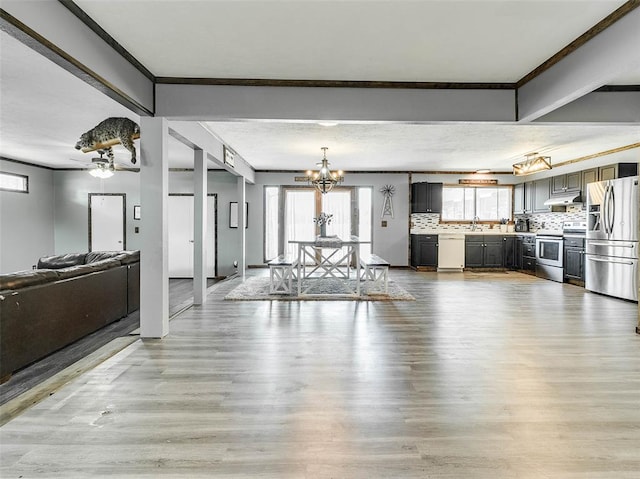 unfurnished living room with crown molding, sink, light wood-type flooring, beam ceiling, and a chandelier