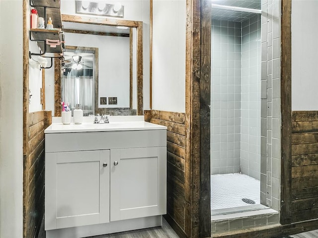 bathroom featuring vanity, tile walls, an enclosed shower, and ceiling fan