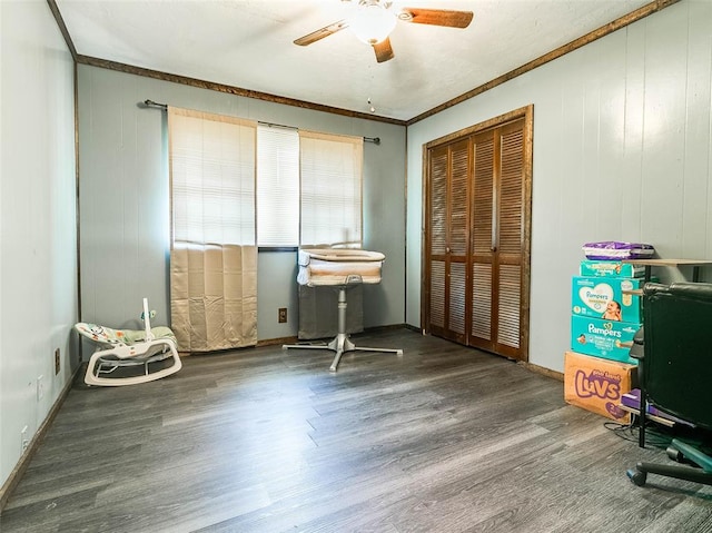 interior space with hardwood / wood-style flooring, ceiling fan, and crown molding