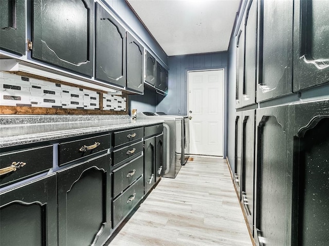 laundry room featuring cabinets and light hardwood / wood-style floors