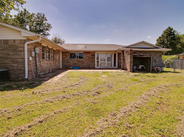 rear view of house featuring a lawn