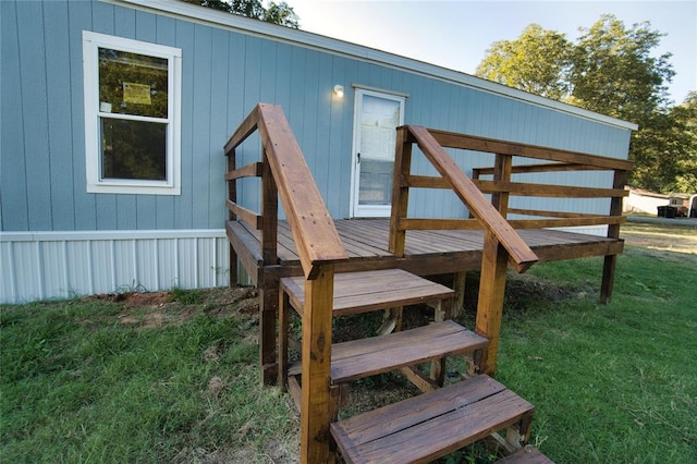 wooden terrace with a lawn