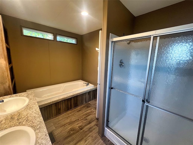 bathroom featuring hardwood / wood-style floors, vanity, and separate shower and tub