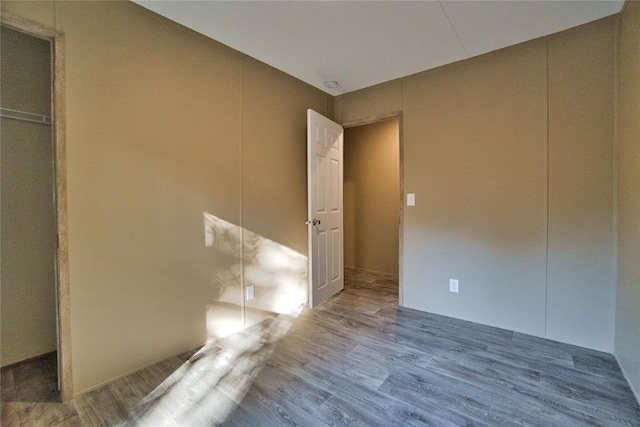 unfurnished bedroom featuring hardwood / wood-style flooring