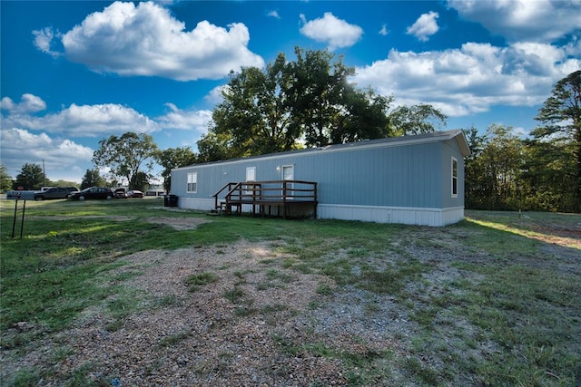 rear view of house featuring a yard