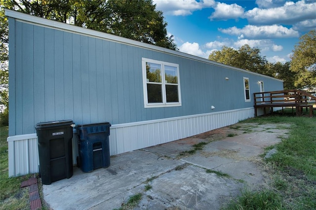 view of side of property featuring a wooden deck