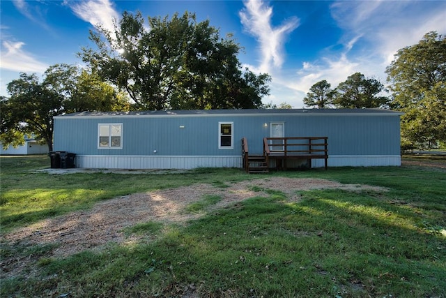 rear view of property featuring a yard