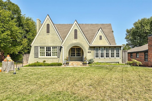 tudor-style house with a front lawn