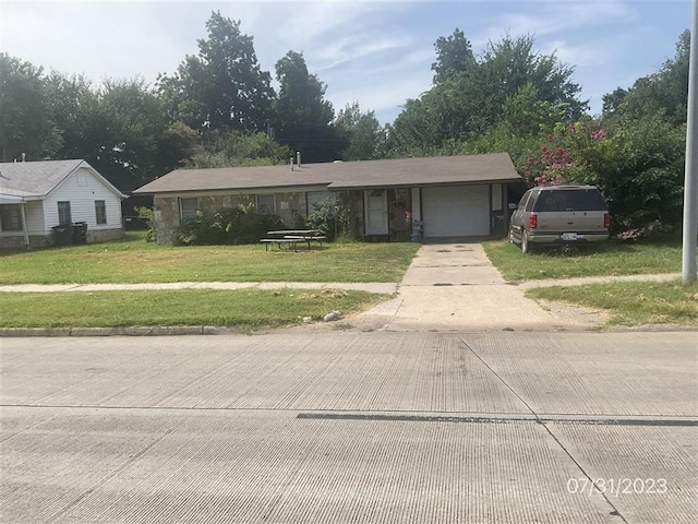 view of front facade with a garage and a front lawn