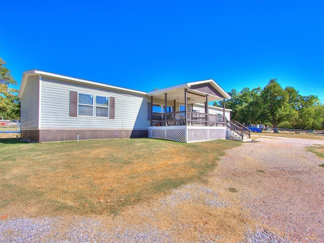 manufactured / mobile home featuring covered porch and a front yard