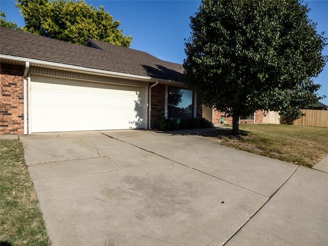 ranch-style house with a front yard and a garage