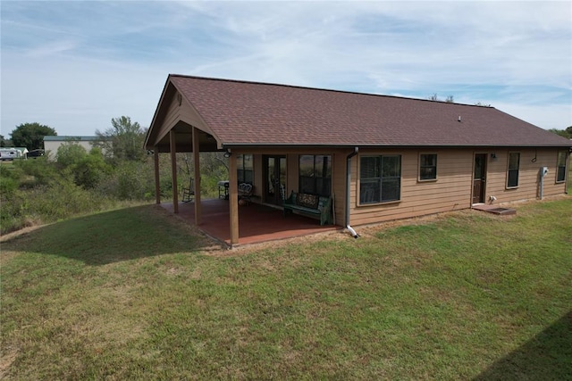 back of property featuring a patio area and a lawn