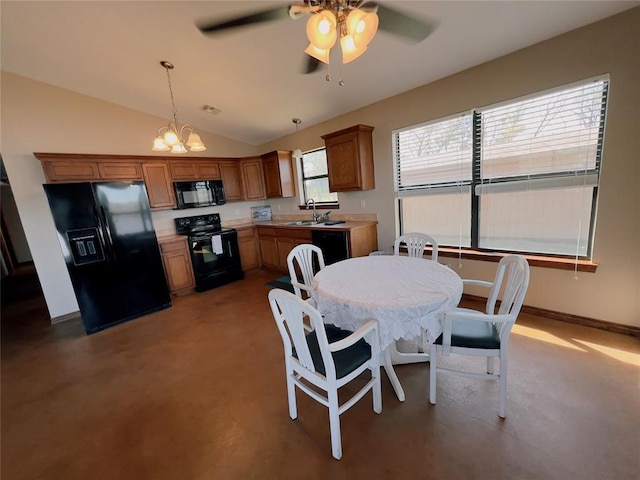 dining area featuring ceiling fan with notable chandelier, lofted ceiling, and sink