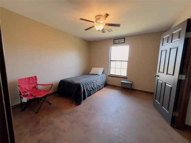 bedroom with ceiling fan and concrete flooring