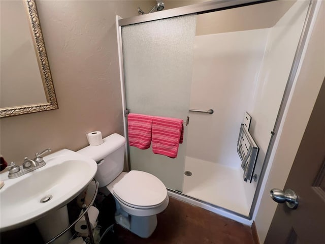 bathroom with sink, toilet, and walk in shower