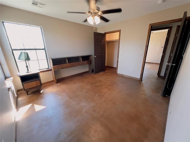 unfurnished bedroom featuring concrete flooring and ceiling fan