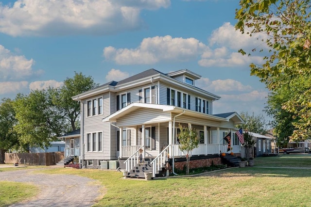 view of front of home featuring covered porch and a front lawn