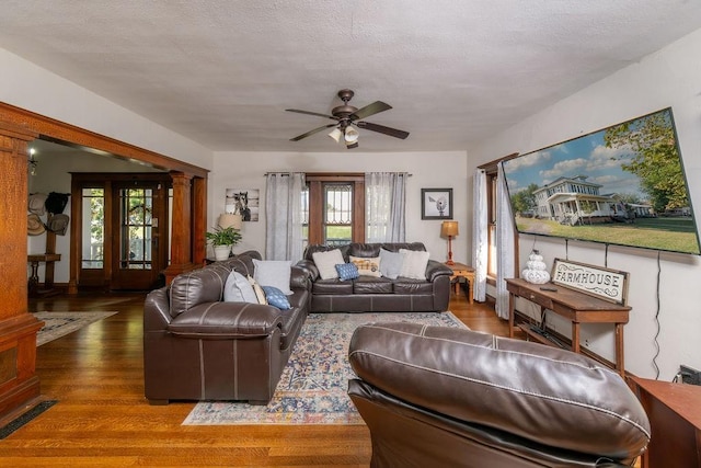 611 Wichita Ave, Devol, OK 73531 - living room featuring ceiling fan, wood finished floors, plenty of natural light, and ornate columns