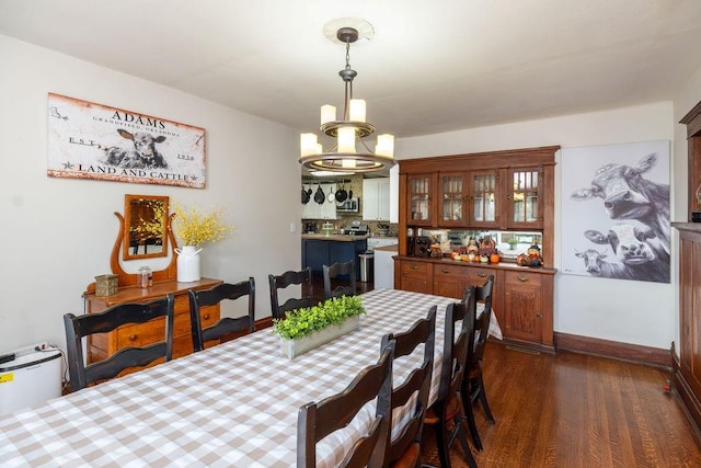 dining room featuring dark hardwood / wood-style floors and an inviting chandelier