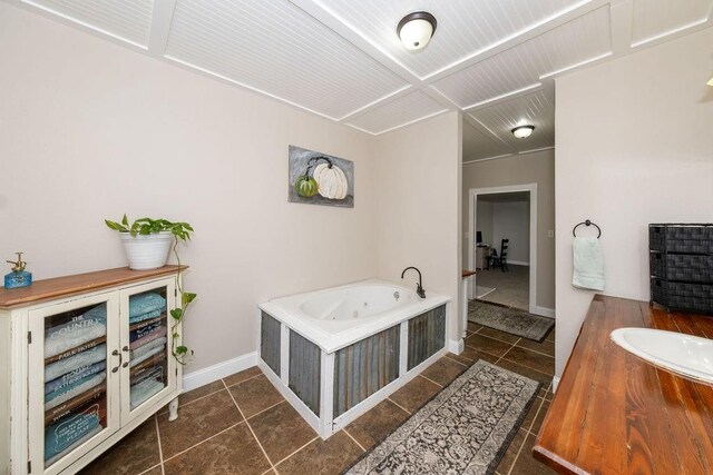 bathroom with tile patterned floors, vanity, and a tub