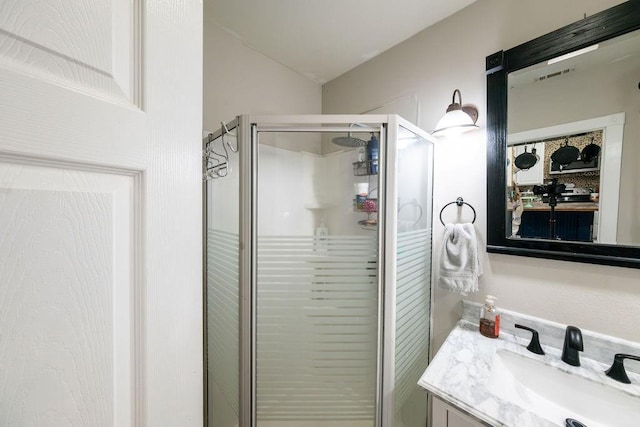 611 Wichita Ave, Devol, OK 73531 - bathroom featuring vanity, a stall shower, and vaulted ceiling