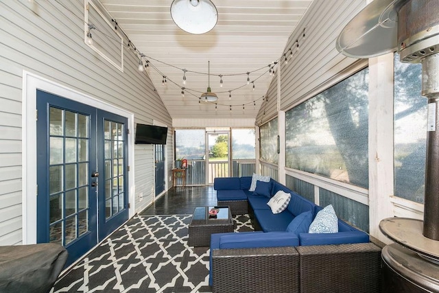 sunroom featuring french doors and vaulted ceiling