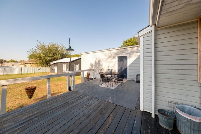 wooden deck featuring a lawn